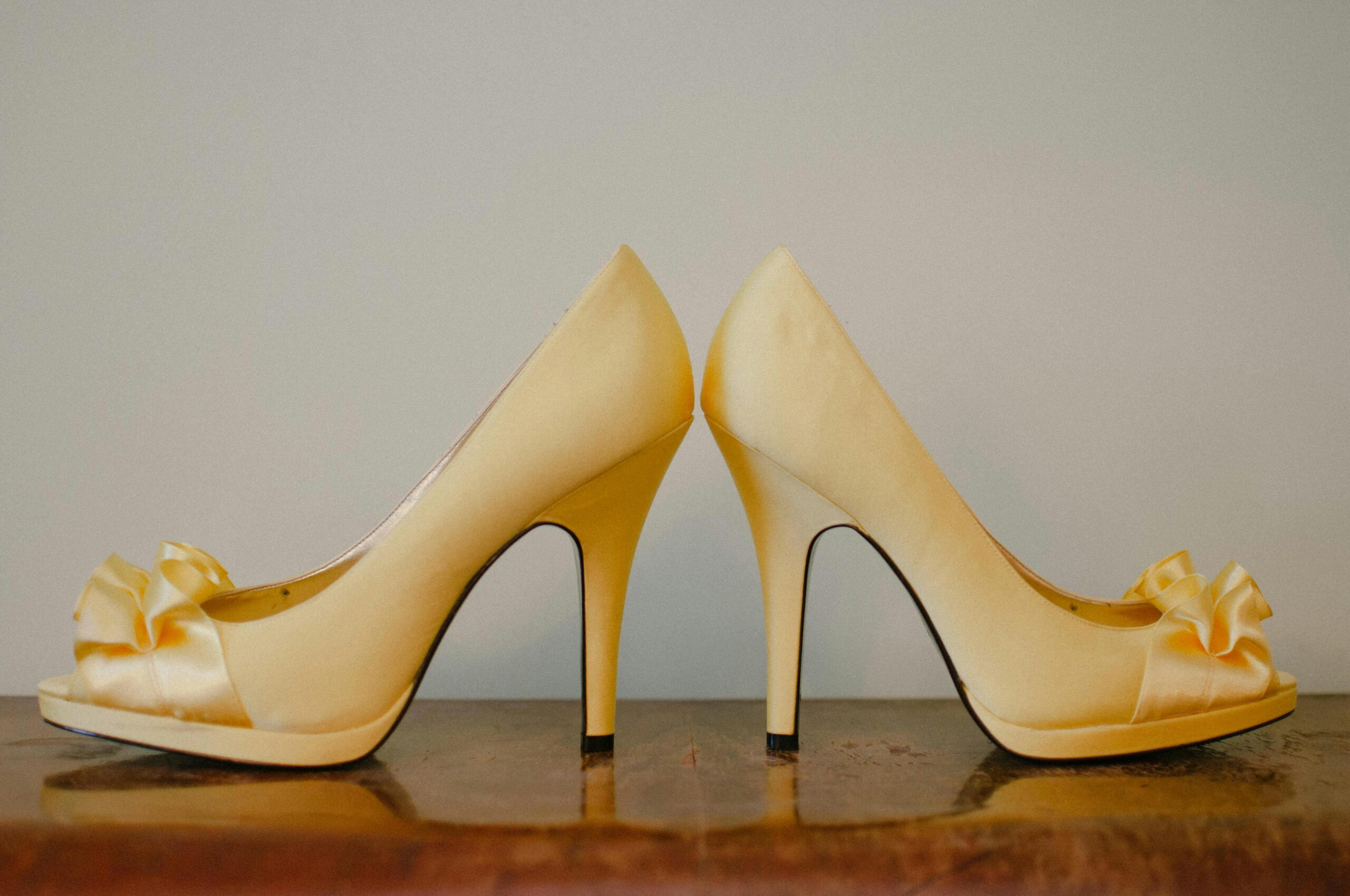 Chic yellow high heel shoes with bows, perfect for luxury fashion aesthetics.